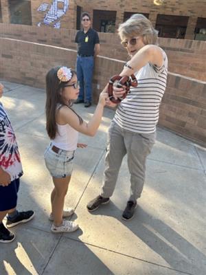 Student touches snake